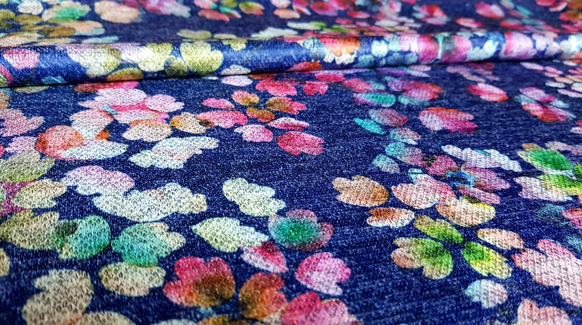 Blue viscose jersey with colourful flowers.